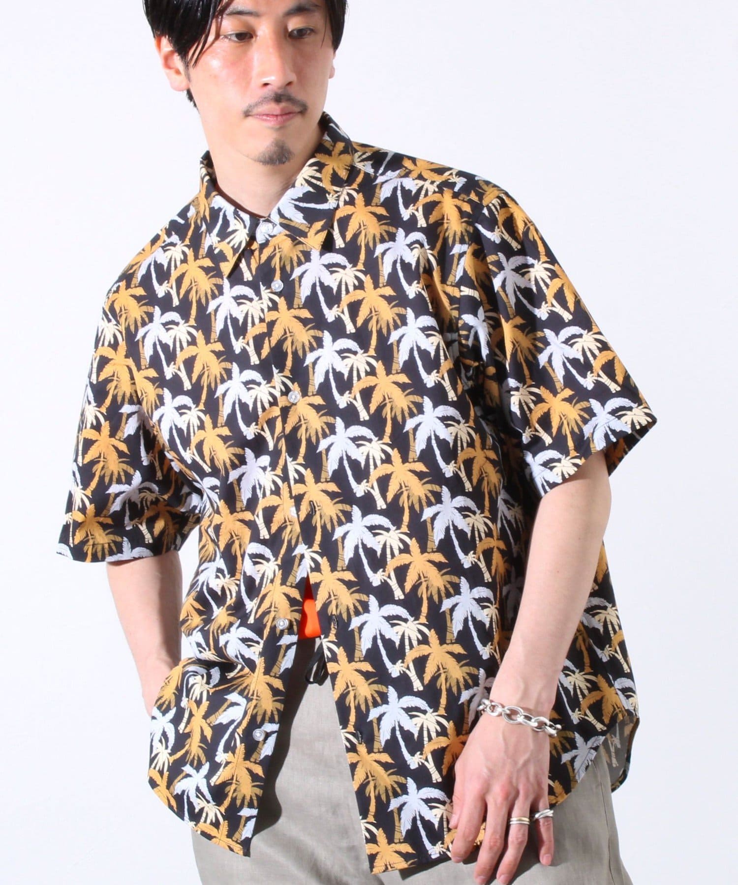 夏定番のアロハシャツをレギュラーカラーを採用することで上品な印象に仕上がりました。パイナップル/サーフショップ/ヤシの木 柄の3パターンをチョイス。ゆったりしたシルエットならがもだらしなく見えない程よ