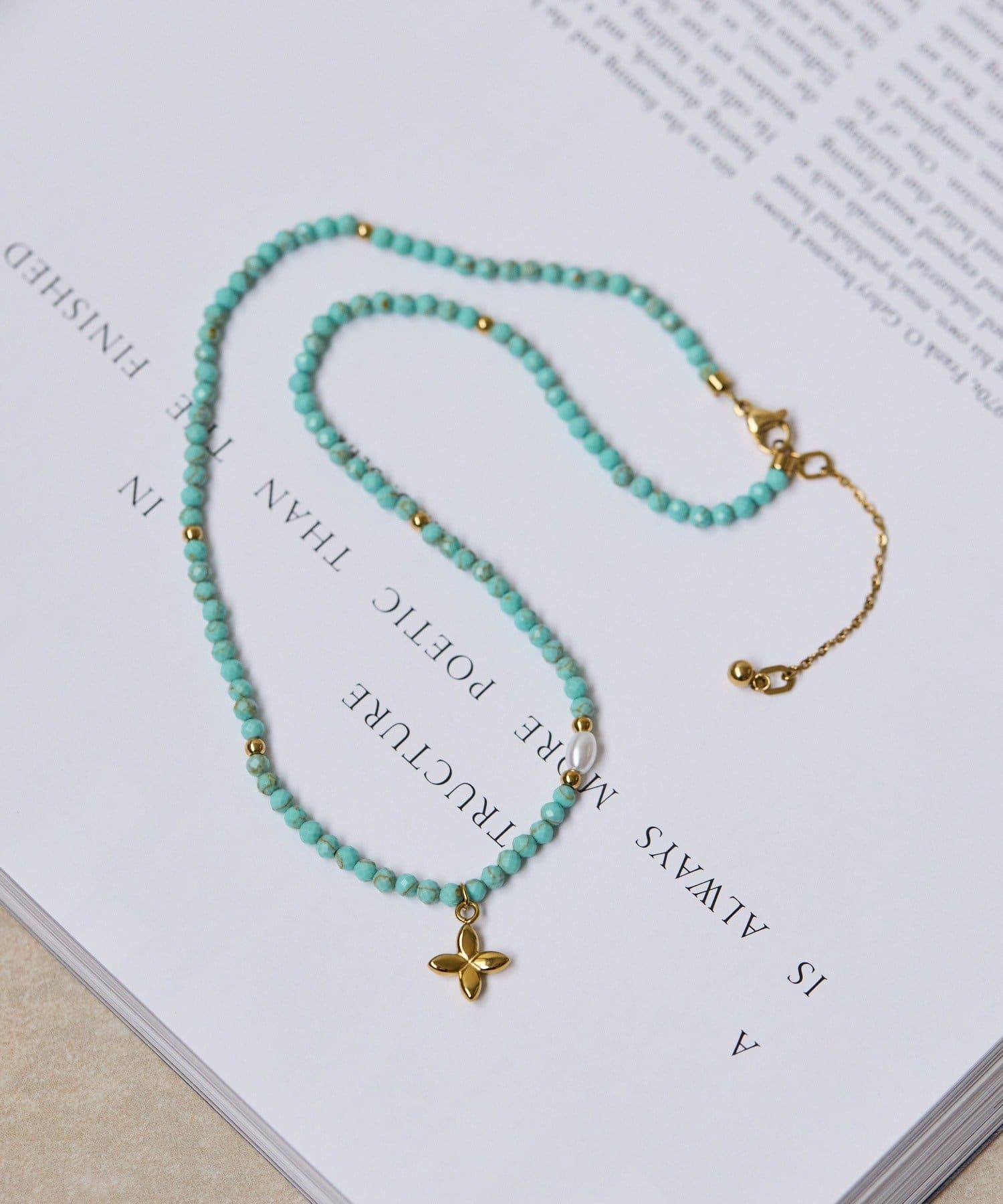 ear PAPILLONNER(イア パピヨネ) 《金属アレルギー対応/ステンレス》ビーズクロスネックレス